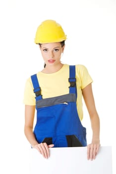 Female construction worker with blank board, isolated on white