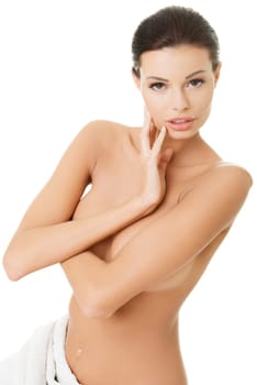 Happy young beautiful topless woman with perfect body posing with white towel around her waist.