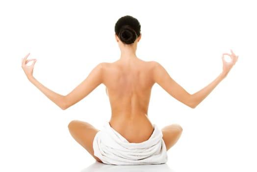 Young beautiful nude woman with towel practicing zoga, isolated on white