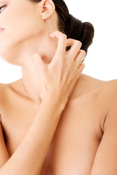 Young beautiful woman scratching her neck. Isolated on white