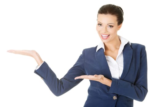 Happy young business woman showing copy space on her palm, isolated on white