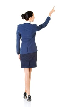 Happy young business woman pointing on copy space, isolated on white