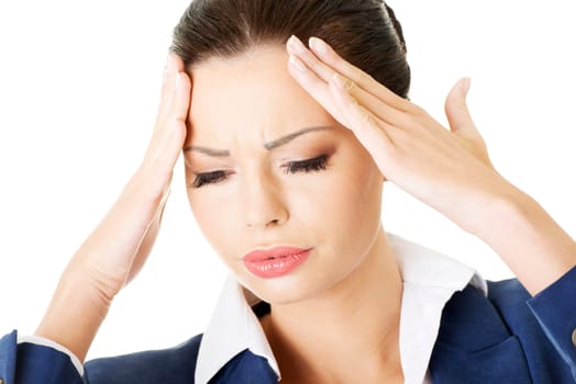 A businesswoman with a headache holding head, isolated on white background