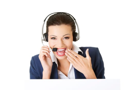 Pretty young call center worker wearing a headset and holding blank sign board