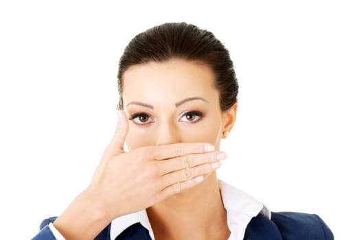 Portrait of young business woman covering with hand her mouth, isolated on white background