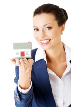 Female businesswoman holding and protecting house. Home protecting concept for insurance or security or real estate