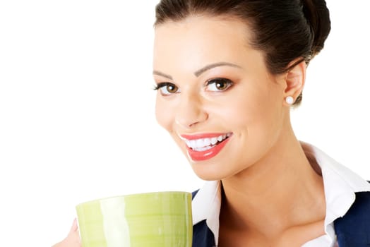 Smiling businesswoman having coffee / tea break isolated on white background