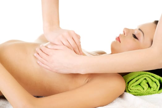 Beauty young woman relaxing in spa. Breast massage.
