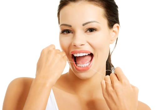 Beautiful young woman using dental floss, isolated on white