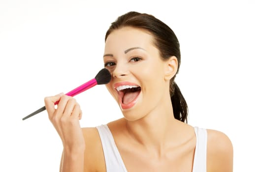 Attractive woman doing make-up on face. Isolated
