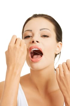 Beautiful young woman using dental floss, isolated on white