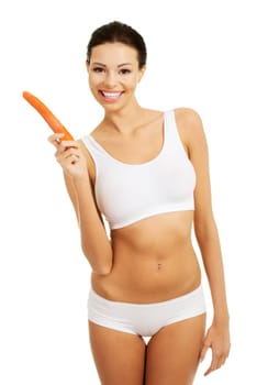 Fit young beautiful woman with carrot, isolated on white