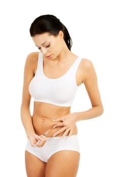 Diabetes woman patient make an abdomen subcutaneous syringe insulin injection with needle