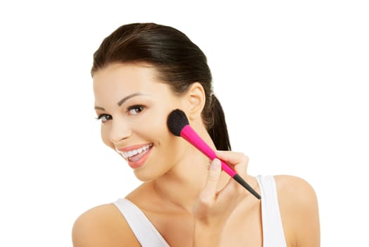 Attractive woman doing make-up on face. Isolated