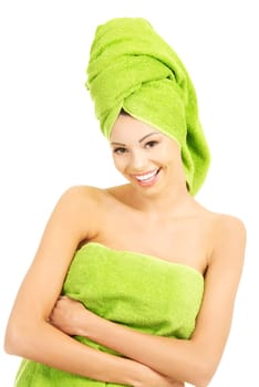 Beautiful happy woman after bath or spa, covered by green towel