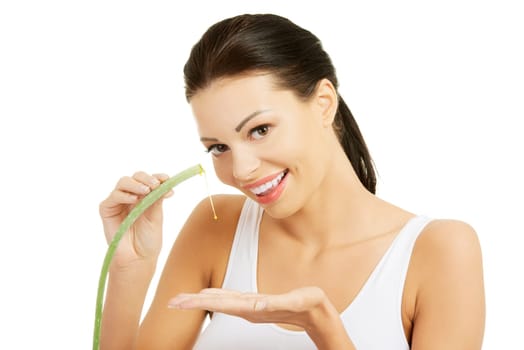 Young beautiful woman's face and aloe vera. Isolated on white background