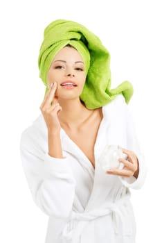 Attractive fit woman with moisturizer cream. Isolated on white background