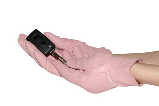 Key from new car in graceful hands in leather pink gloves isolated on white