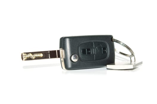 Car key isolated on white with shadows and reflection