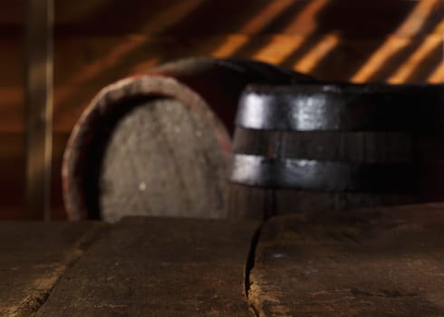 Closeup of a vintage table in a vintage beer cellar with barrels in the background