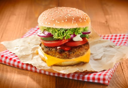 Hamburgers and french fries with sesame bun on brown paper and napkin
