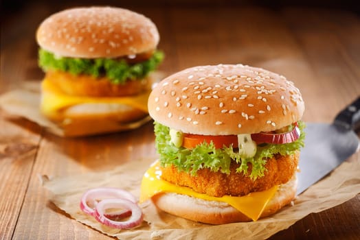 Fast food meanl made of two tasty hamburgers with meat, cheese, onion and salad