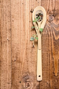 Brown wooden spoon and a sprig of green