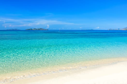 Tropical sandy beach Malcapuya at summer sunny day