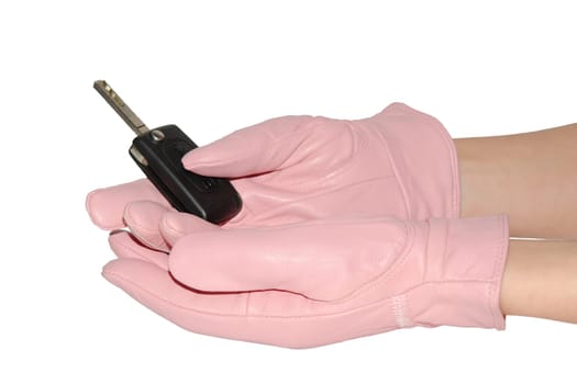 Hands in elegan pink gloves holding automobile key