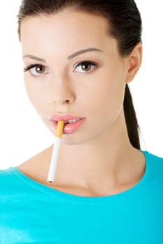Smoking addiction. Young woman with cigarette in her mouth. Isolated on white