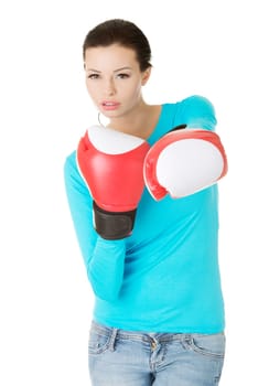 Young woman wearing a pair of boxing gloves. Woman ready for fight with problems concept.