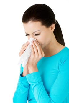 Young woman with tissue - sneezing. Allergy or cold.