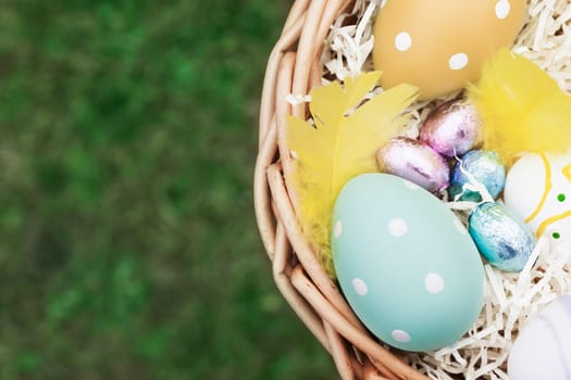 Decorated eggs and candy in Easter Basket, with copy space.