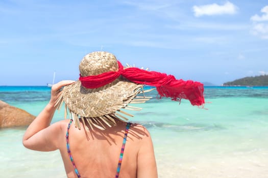 Woman with sun hat on the beach - Seychelles