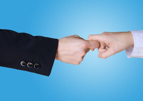 two business hands in rivalry on a blue background
