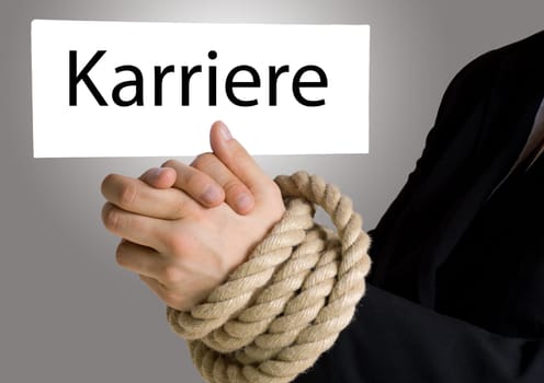 business hands in chains holding a banner with the german words Karriere on it