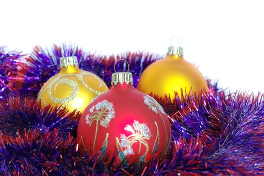 Christmas tinsel and toys on a white background