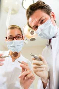 Dentist with dental assistant during a treatment from the patient's point of view