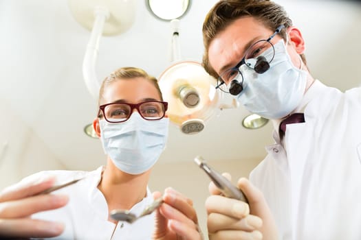 Dentist with dental assistant during a treatment from the patient's point of view