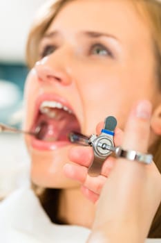 Dentist holding a syringe - anesthesia in a patient