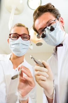 Dentist with dental assistant during a treatment from the patient's point of view