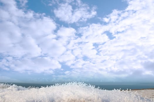 a seasonal crisp snow frosty covered grass ditch with a view of the atlantic ocean