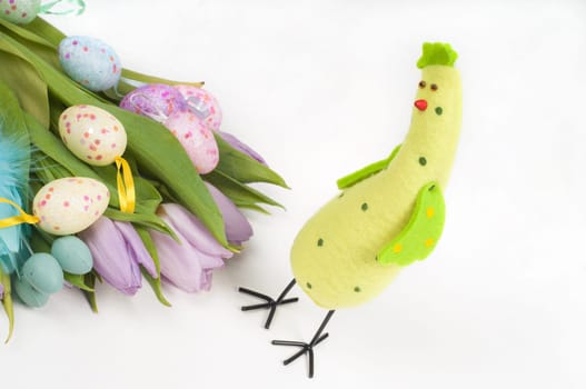 Easter chicken with tulips and eggs on light background