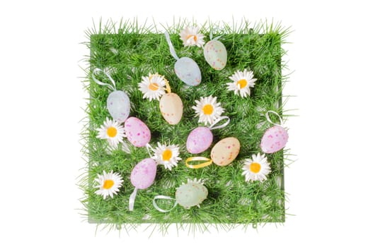 Easter eggs on the grass isolated on white