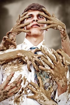 Young man stained by multitude of dirty hands