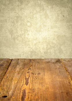 Rustic wooden table in front of weathered wall