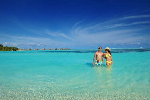 happy young asian couple have fun and romantic time at  summer on beautiful white sand beach