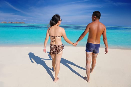 happy young asian couple have fun and romantic time at  summer on beautiful white sand beach