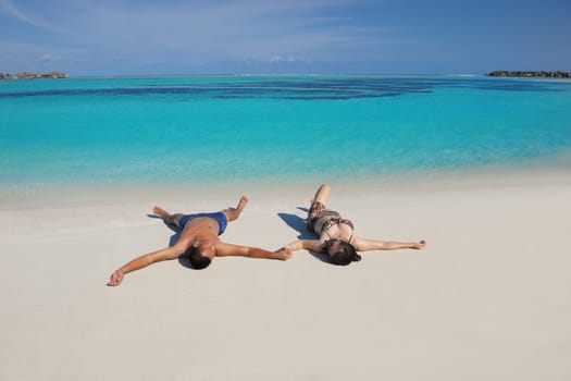 happy young asian couple have fun and romantic time at  summer on beautiful white sand beach