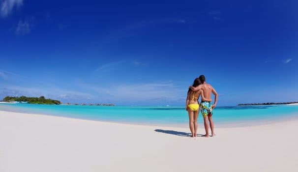 happy young asian couple have fun and romantic time at  summer on beautiful white sand beach